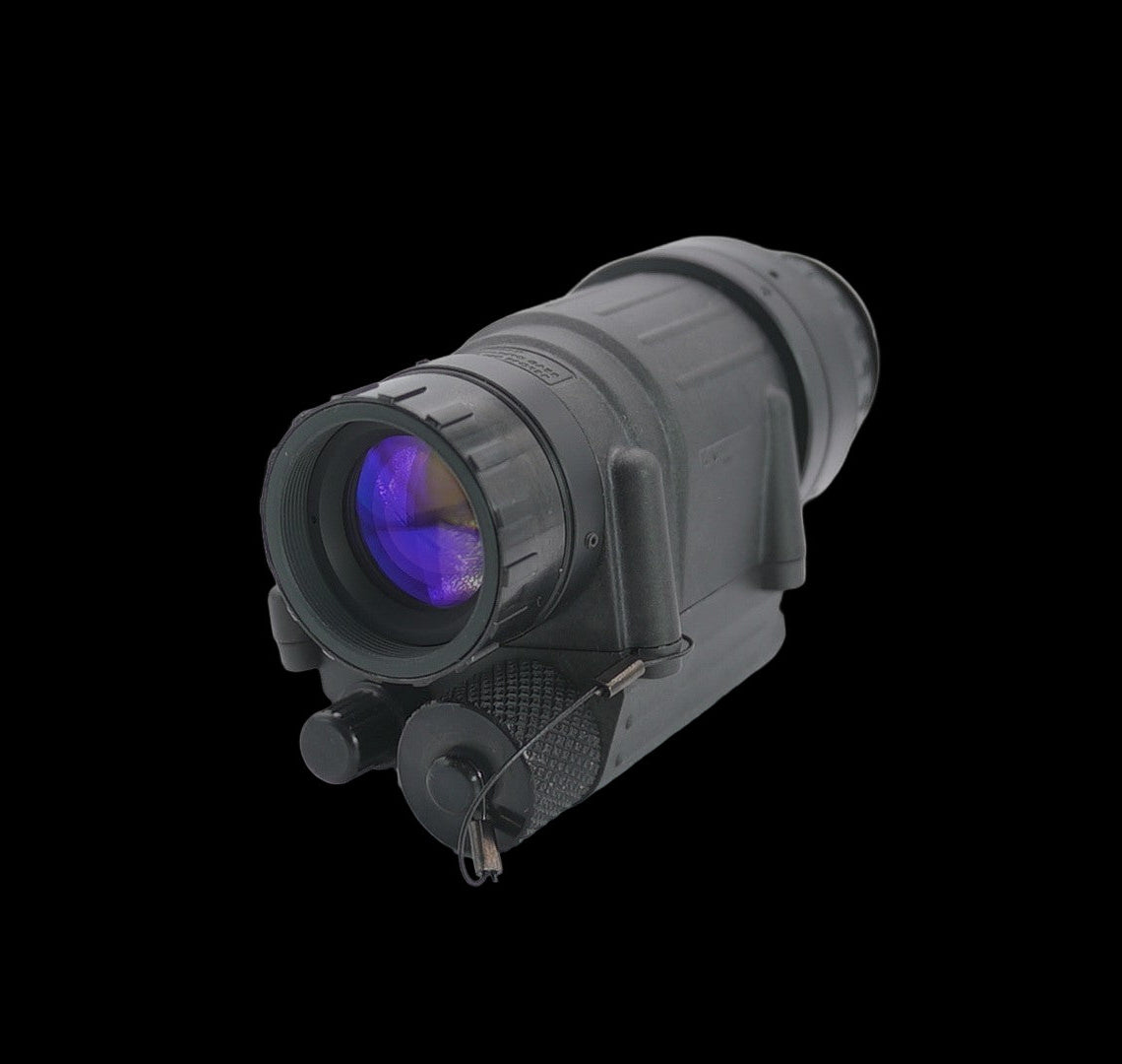 Black night vision scope on a light gray background